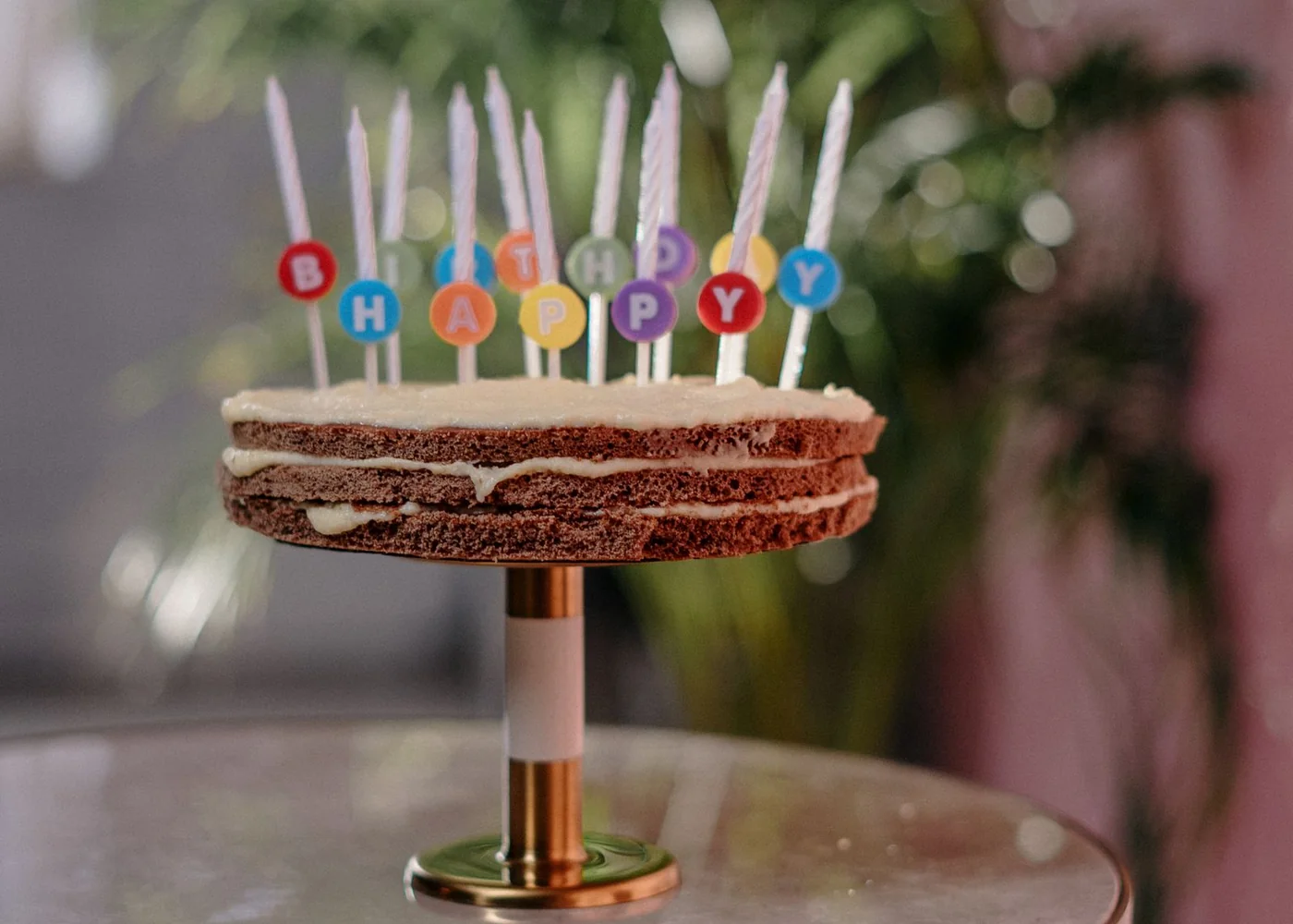A small birthday cake decorated with colourful candles.