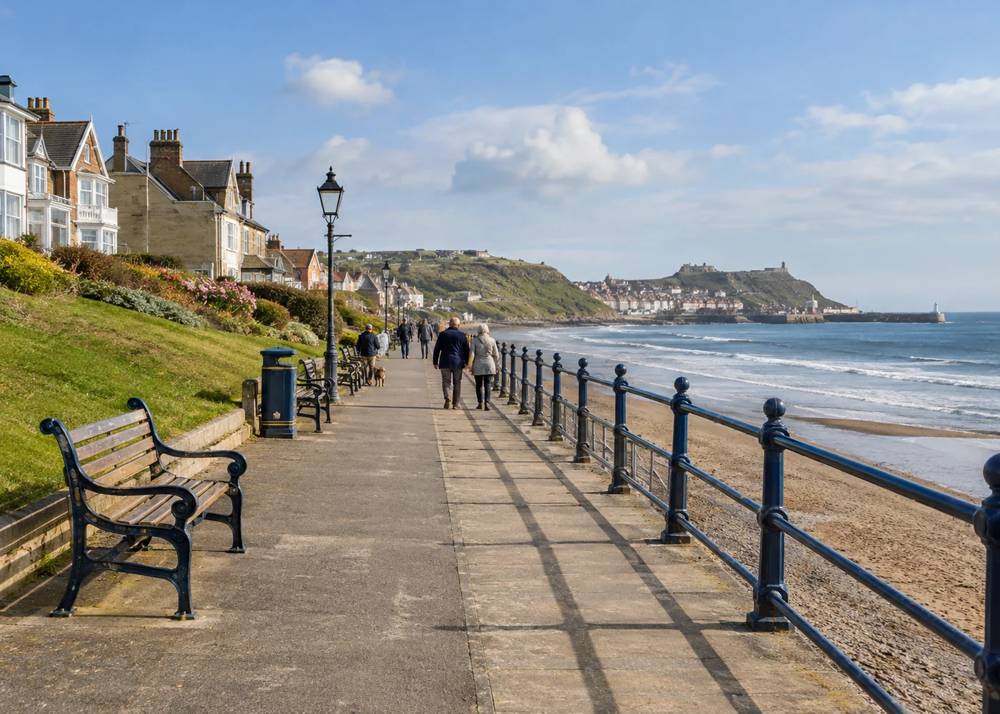 Long seaside promenade with benches and railings.