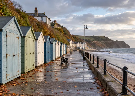 Quiet seaside promenade in autumn with closed beach huts.