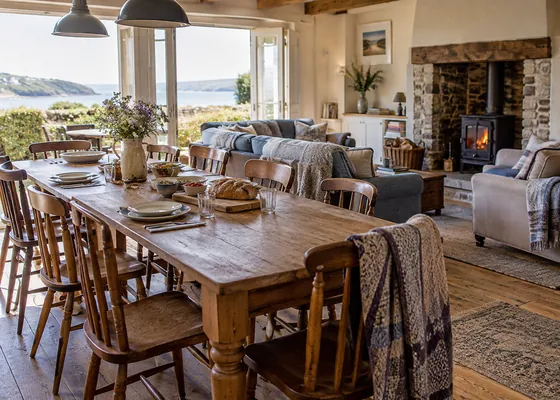 Long dining table beside a comfortable sitting area.