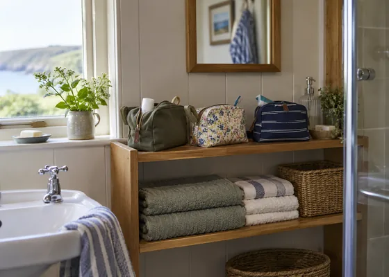 Bathroom shelf with separate washbags.